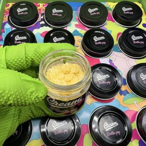 Cream Live Resin cannabis concentrate, showcasing a smooth, golden texture ideal for potent dabbing or vaping.